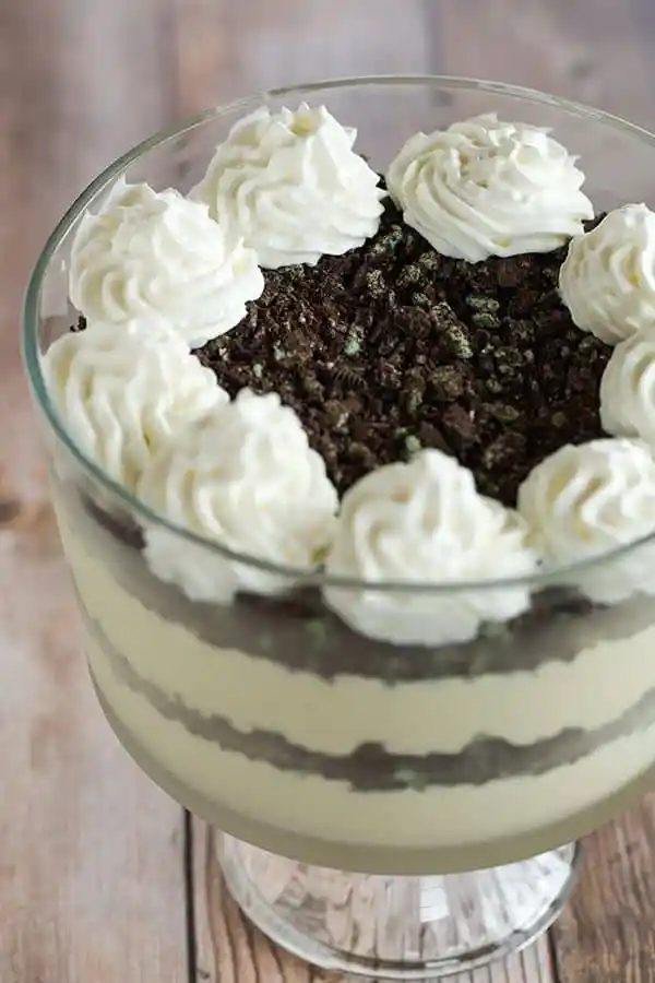 Baileys White Chocolate Mousse - Spiked white chocolate mousse layered into a trifle dish with crushed mint Oreos. A straightforward dessert for your St. Patrick's Day celebration!