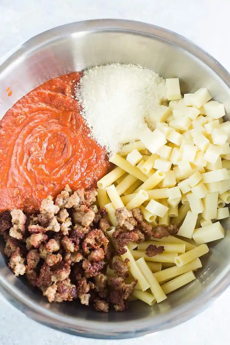A big bowl with all of the ingredients for baked ziti.
