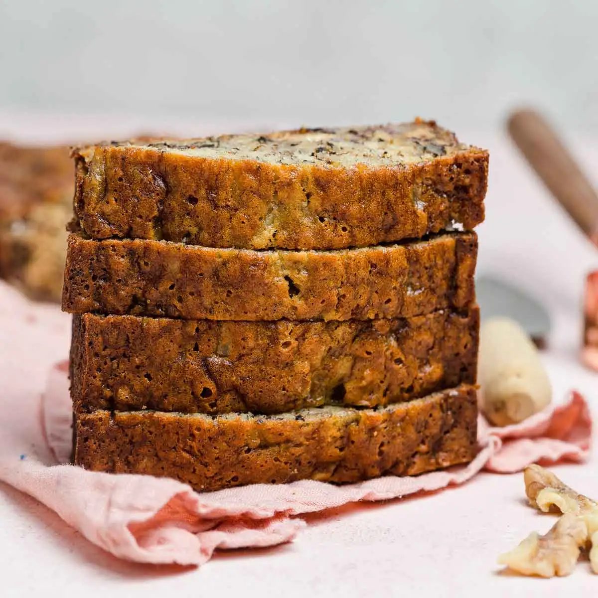 Front view of stack of four slices of banana nut bread.