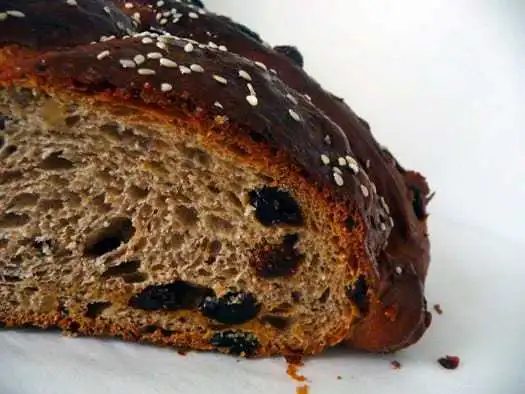 Loaf of Christopsomos with a slice removed showing the texture.