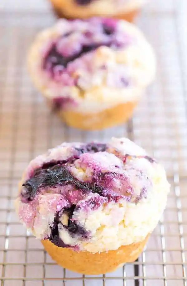 These blueberry muffins are loaded with fresh blueberries, have a fresh blueberry jam swirl throughout and are topped with sugar for a crisp bite!