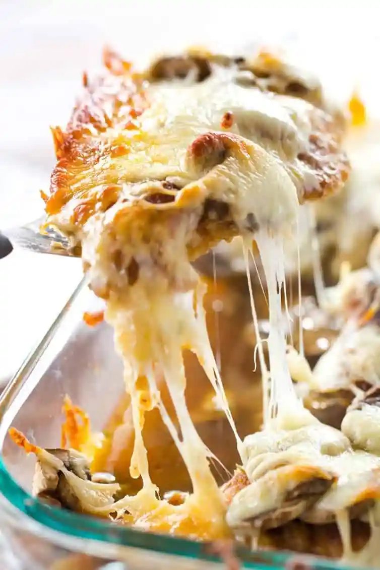 Cheesy Chicken with Mushrooms - Breaded chicken cutlets layered with sliced mushrooms and mozzarella. Straightforward dinner! |