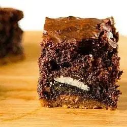 Chocolate chip cookie and Oreo brownie on a wood board.