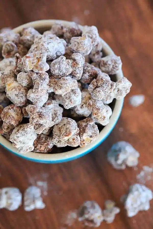This popcorn version of the enormously popular muddy buddies (or "puppy chow") is chocolate and peanut butter-covered popcorn tossed in powdered sugar. |
