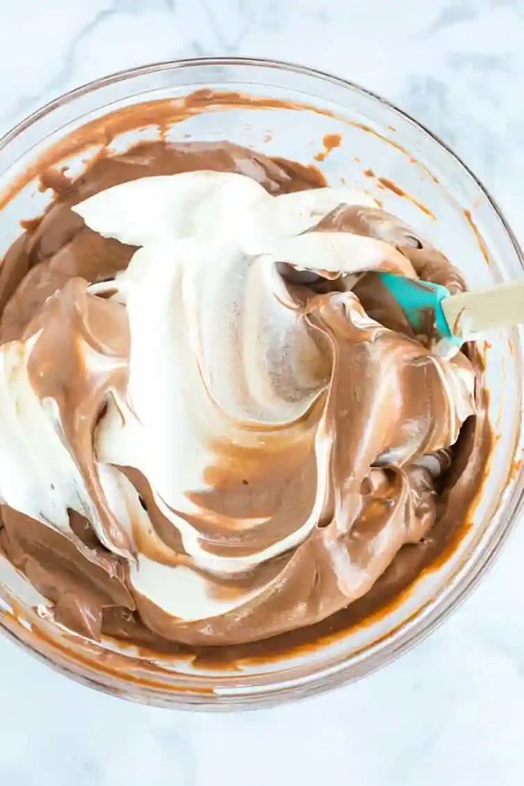 Making dirt dessert - folding whipped cream into chocolate mousse!