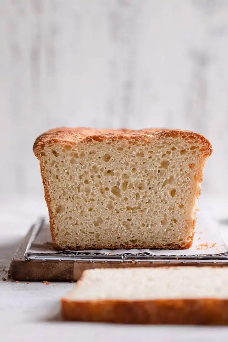 Sliced english muffin bread on a cutting board.