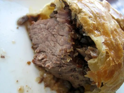 Showing the inside texture of beef Wellington.