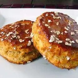2 maple oatmeal scones on a white plate.
