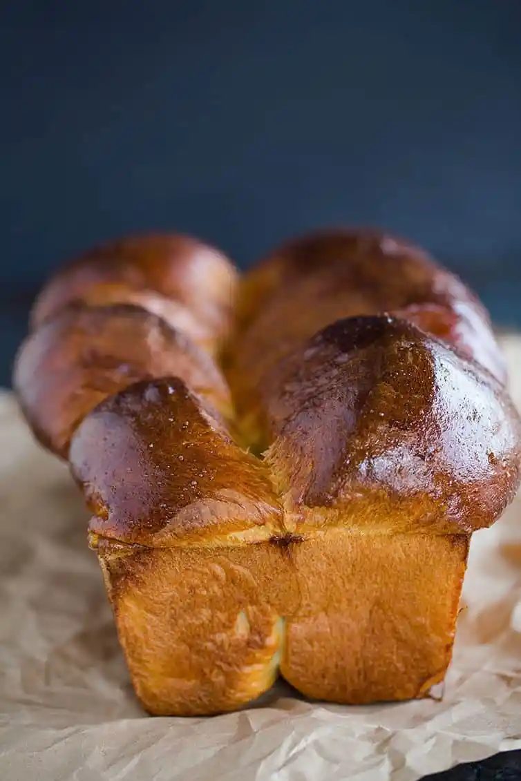 One loaf of milk bread on a piece of parchment paper.