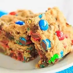 Monster Cookie Bars - Peanut butter dough is loaded with oats, chocolate chips and M&M's. |