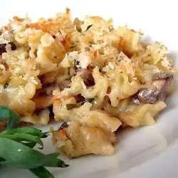 Mushroom and herb macaroni and cheese on a white plate.