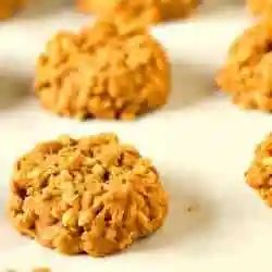 No bake peanut butter butterscotch cookies on a parchment paper lined baking sheet.