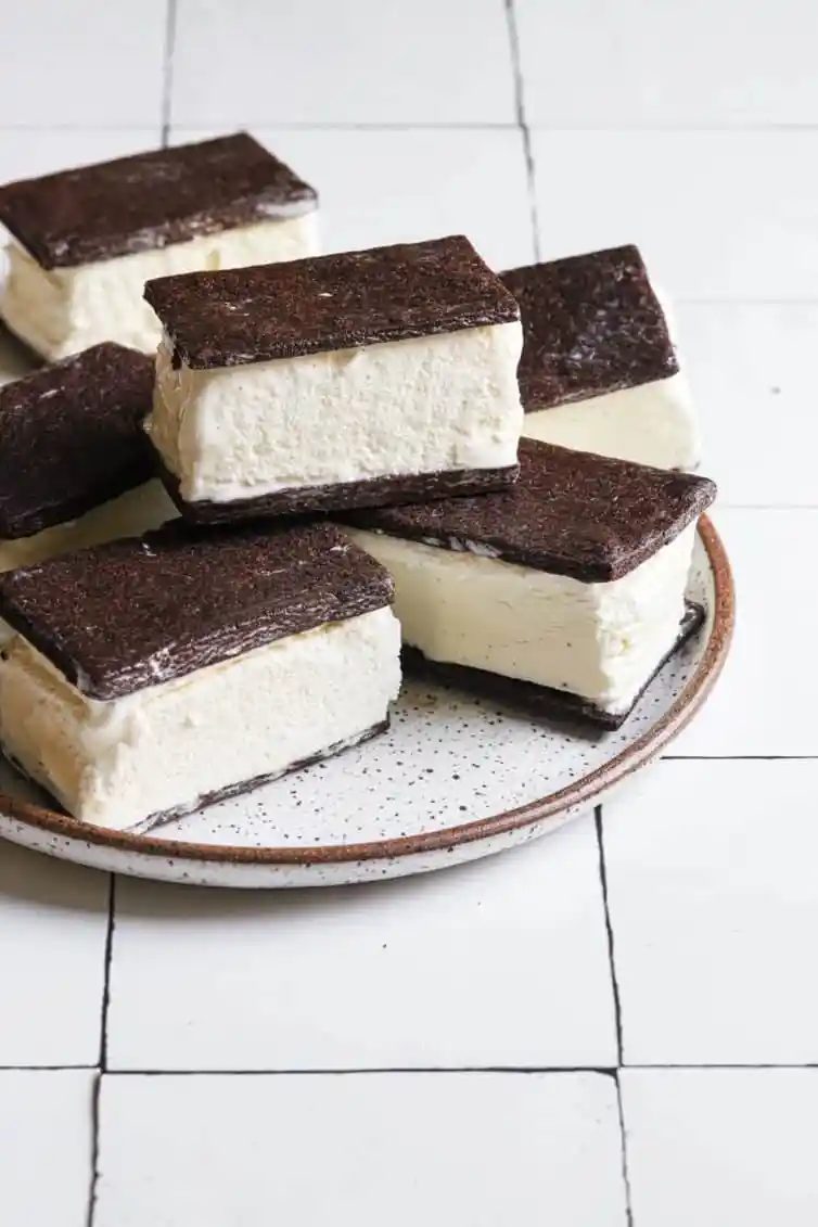 From-scratch ice cream sandwiches on a white plate with a brown rim.