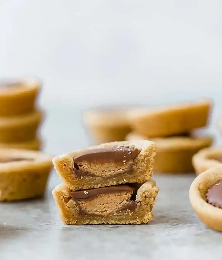A peanut butter cup cookie cut in half and stacked.