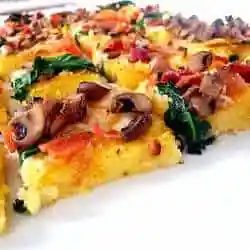 Squares of polenta pizza topped with vegetables.