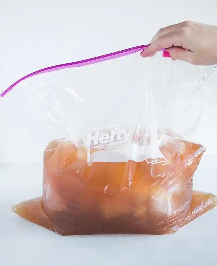 Pork butt in a brine in a large plastic bag.