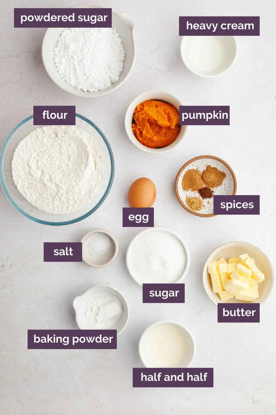 Ingredients for pumpkin scones prepped in bowls and labeled.