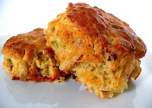 2 quiche lorraine scones on a white plate.