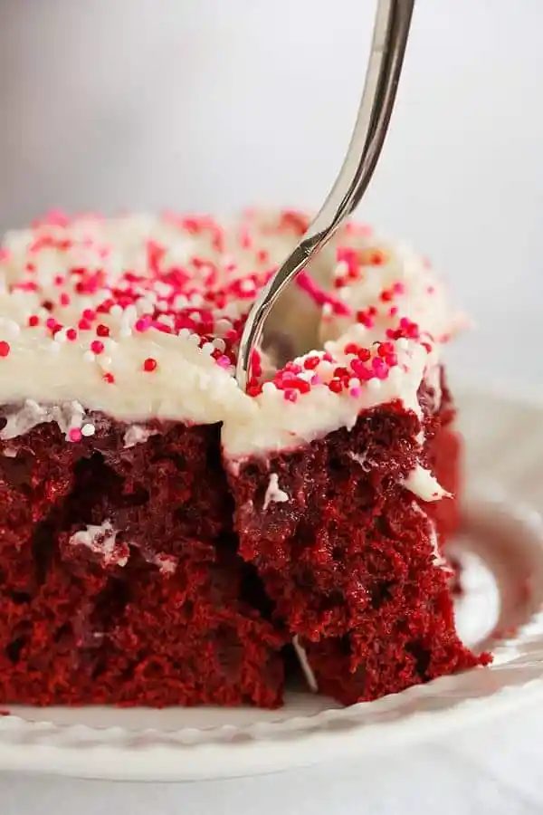 Red velvet cake is infused with sweetened condensed milk and topped with a standby cream cheese frosting. A must for Valentine's Day!