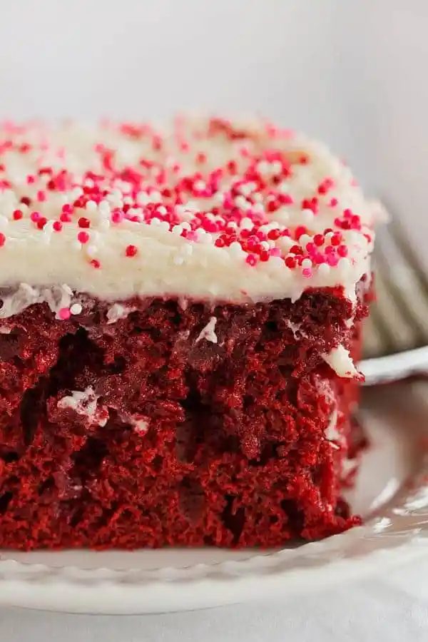 Red velvet cake is infused with sweetened condensed milk and topped with a standby cream cheese frosting. A must for Valentine's Day!