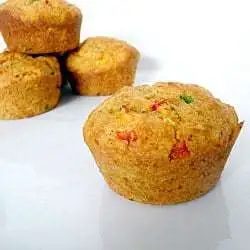 Corn muffins with peppers on a white plate.