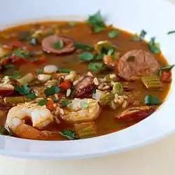 Shrimp and sausage jambalaya in a white bowl.