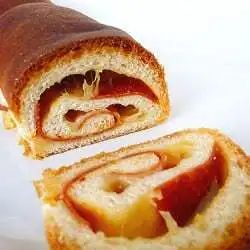 Swirled cheese and pepperoni bread with a slice cut showing the inside.
