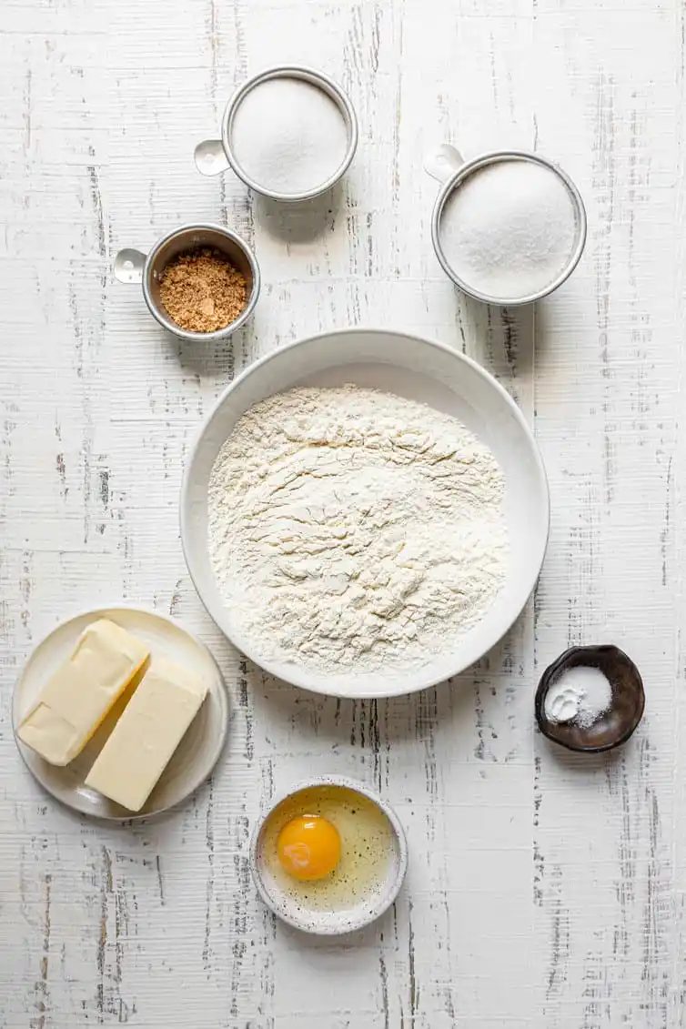 Ingredients for sugar cookies prepped in bowls.