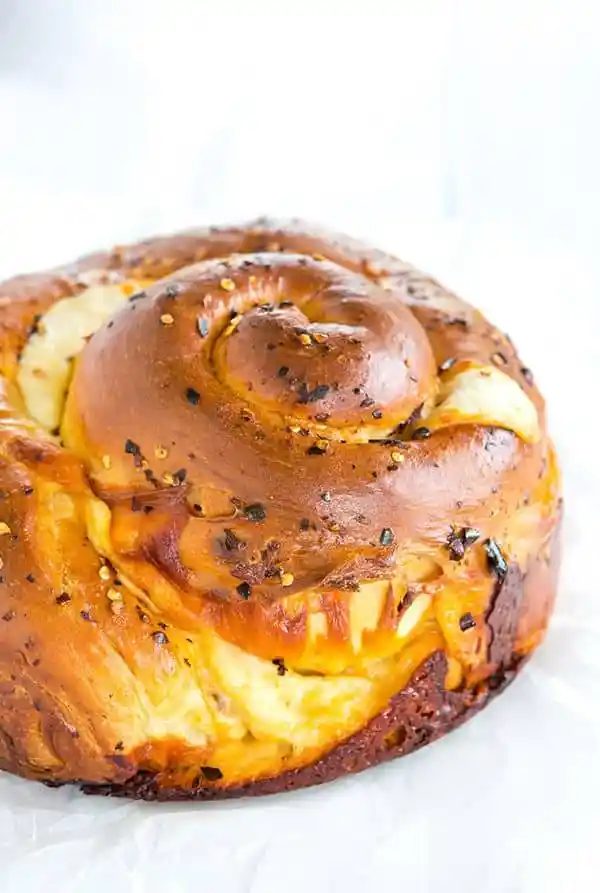 Spicy Cheese Bread - This recipe makes a huge loaf of a rich brioche-like bread loaded with provolone and Monterey Jack cheeses, and speckled with crushed red pepper flakes. |