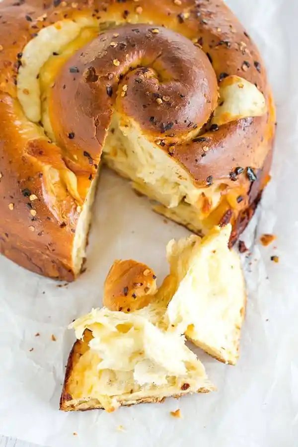 Spicy Cheese Bread - This recipe makes a huge loaf of a rich brioche-like bread loaded with provolone and Monterey Jack cheeses, and speckled with crushed red pepper flakes. |