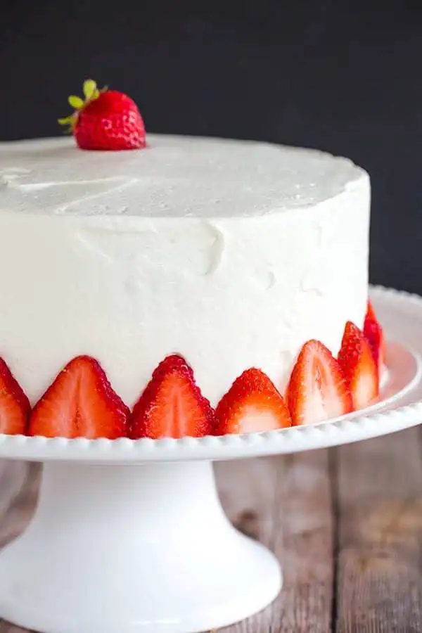 Strawberry Poke Cake - A two-layer beauty with the most memorable fresh sweet whipped cream. A reliable summer celebration cake!