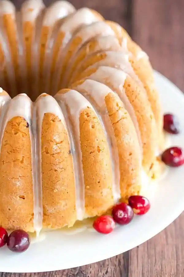 This Cranberry Pound Cake is wonderfully dense, plush and loaded with fresh cranberries. Topped with a simple orange glaze, it's reliable for the holidays.
