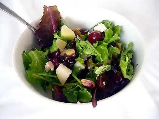 Salad in a white bowl.