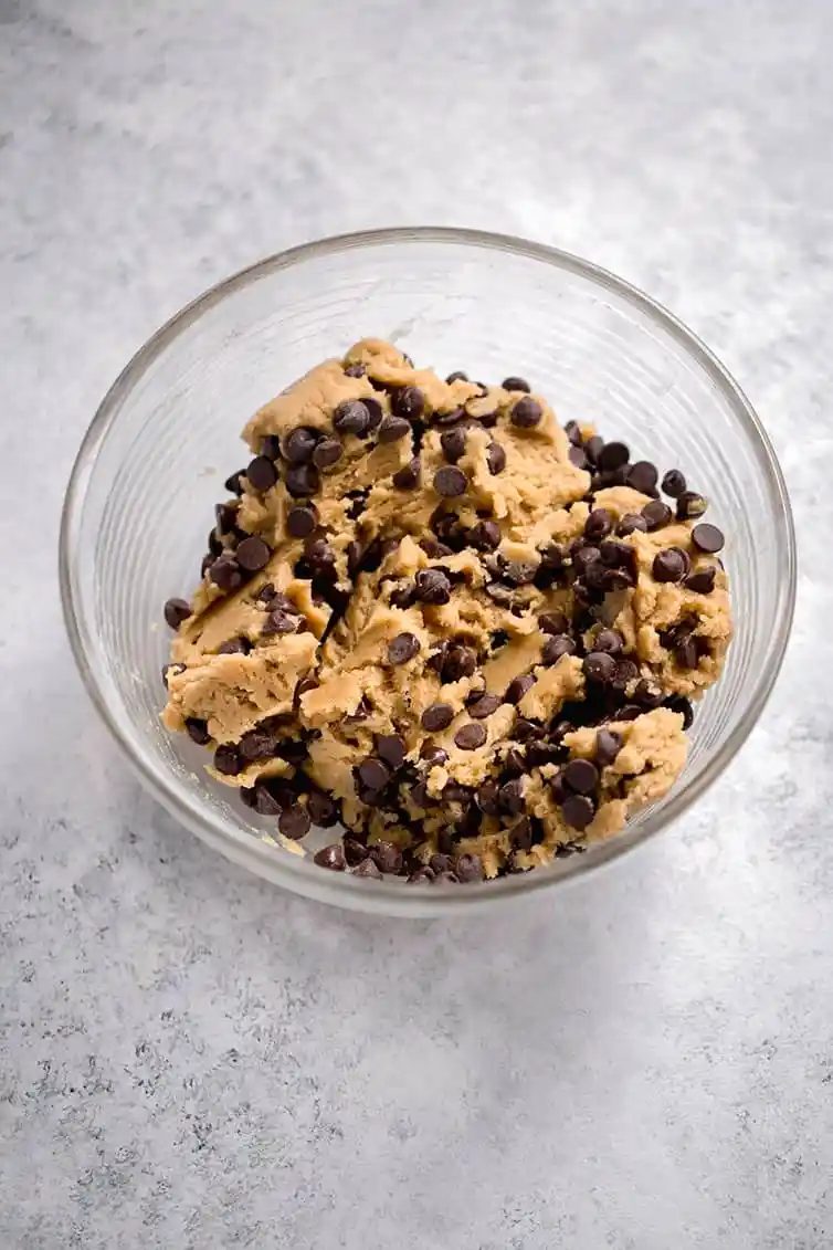 Chocolate chip cookie dough in a mixing bowl.