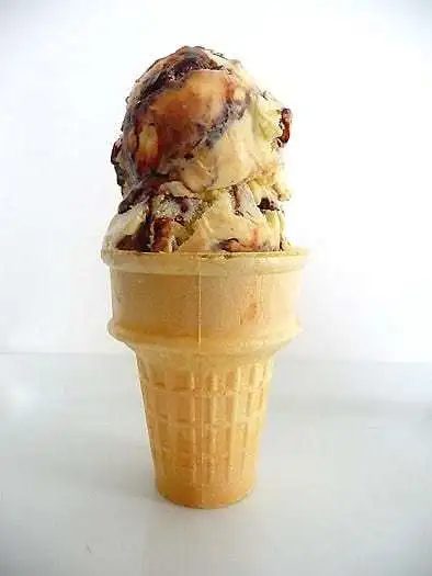 Ice cream cone with 2 scoops of tin roof ice cream.