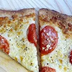 2 slices of white Sicilian pizza on a wood surface.