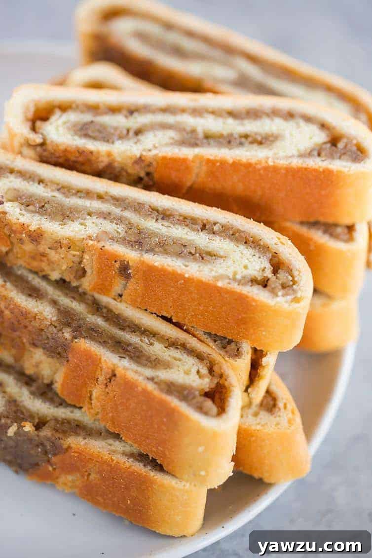 A plate with slices of traditional nut roll, a festive holiday pastry.