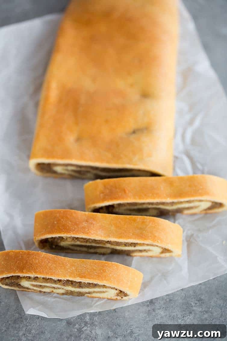 An overhead view of freshly baked and perfectly sliced nut roll, showcasing the rich walnut filling.