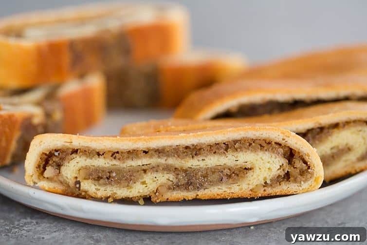 A plate with slices of nut roll, a festive and traditional sweet pastry.