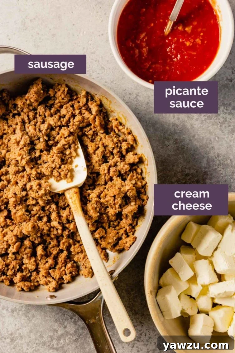 Three bowls on a grey counter with ingredients for sausage dip labeled with purple text boxes.
