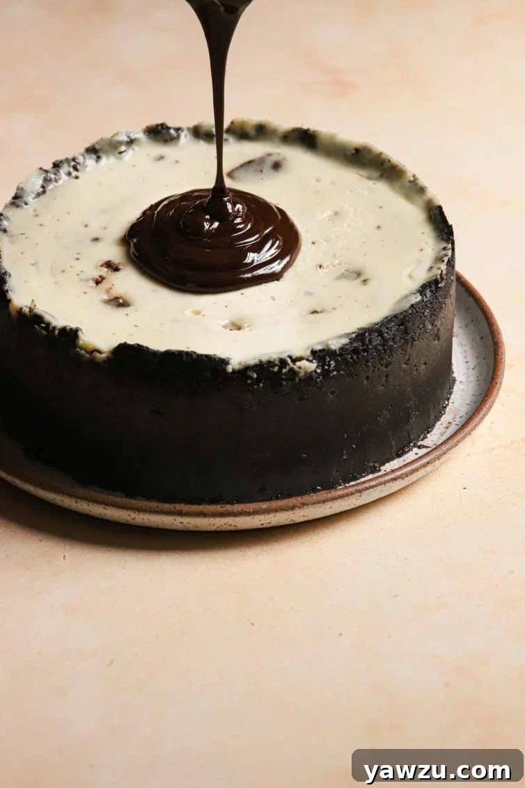 topping this brownie cheesecake with the smooth chocolate ganache, creating a beautiful glaze