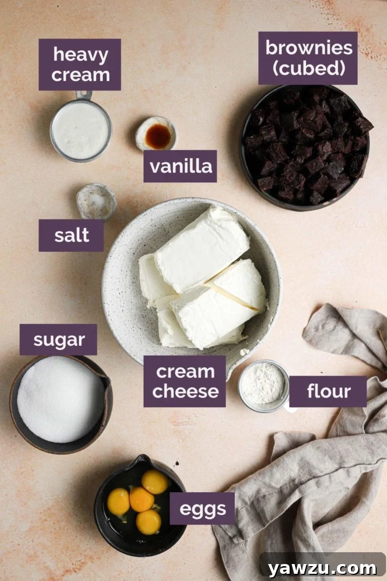 labeled ingredients for this delicious brownie cheesecake recipe, showcasing cream cheese, sugar, flour, eggs, cream, vanilla, and brownie cubes