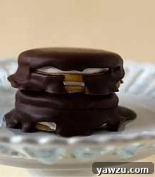 Stack of 2 moon pies on a white dessert stand.