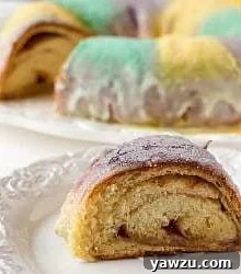 Slice of king cake on a white plate.