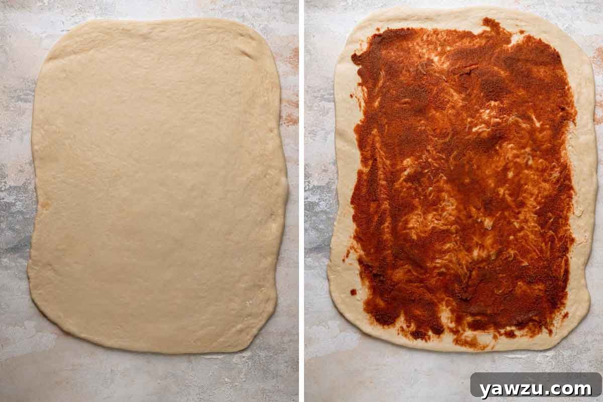 King cake dough rolled out and cinnamon sugar filling spread over the surface.