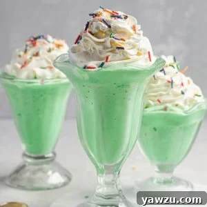 Three milkshake glasses filled with copycat McDonald's shamrock shakes.