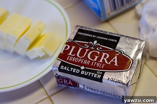 Various ingredients for salted caramel ice cream laid out on a counter, including a block of salted butter.