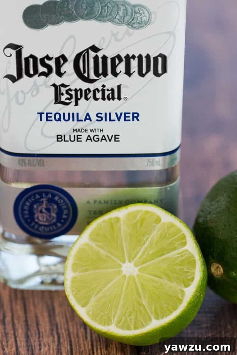 Prep for margarita cupcakes: a bottle of silver tequila and halved lime.