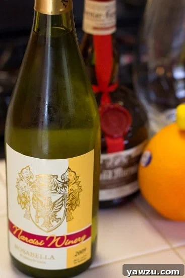 A pristine bottle of white wine, likely Pinot Grigio or Chardonnay, standing against a clean white background, ready to be used in sangria.