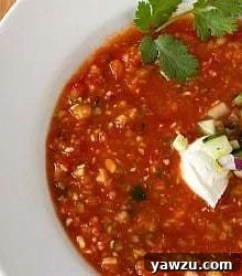Overhead image of gazpacho in a white bowl.